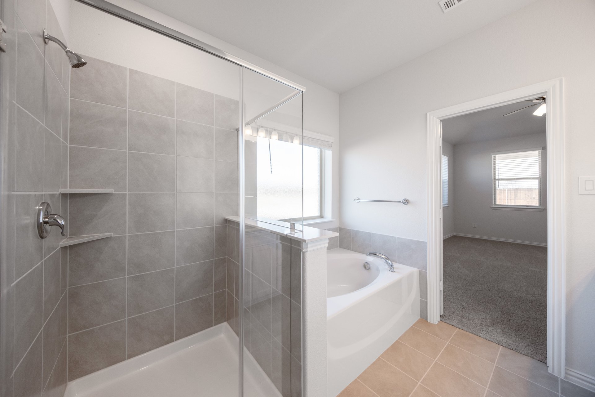 bathroom with walk-in shower and soaking tub