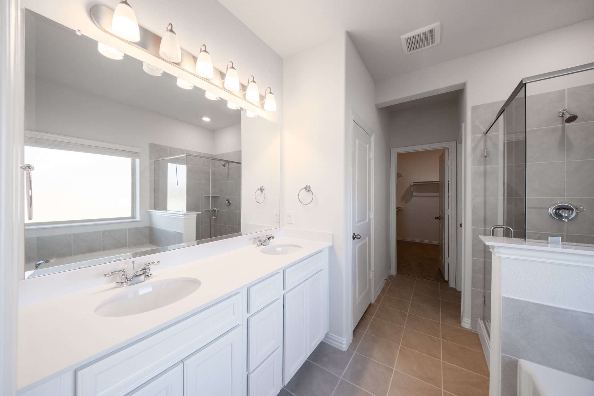 bathroom with white countertops and cabinets