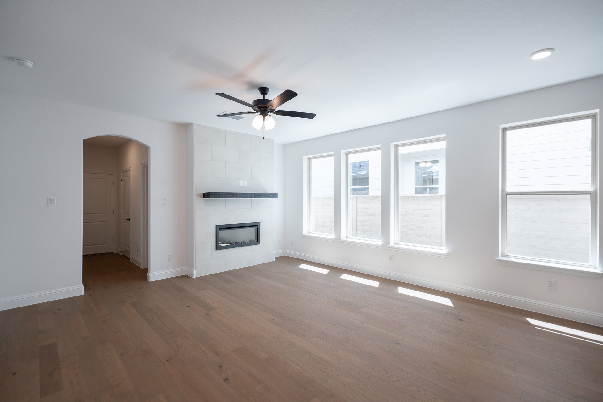 open great room with wood floors and fireplace