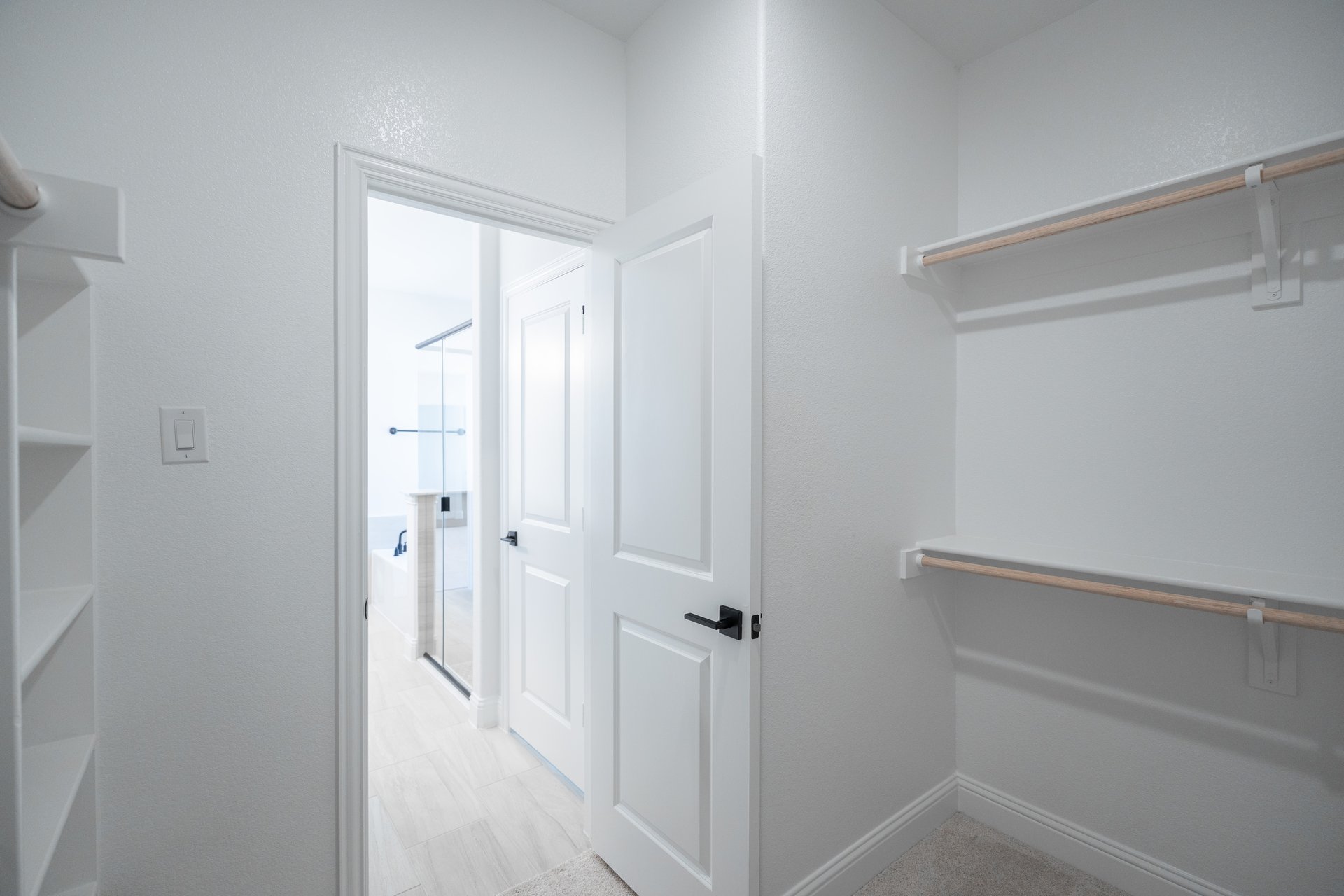 primary bedroom closet with carpet and white shelves