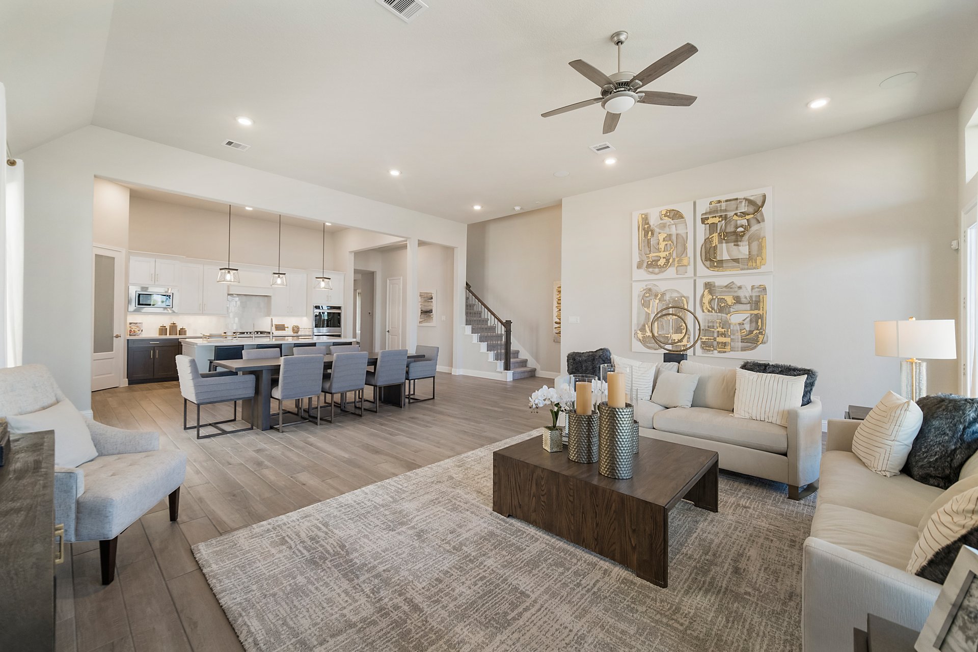 great room with ceiling fan and rug
