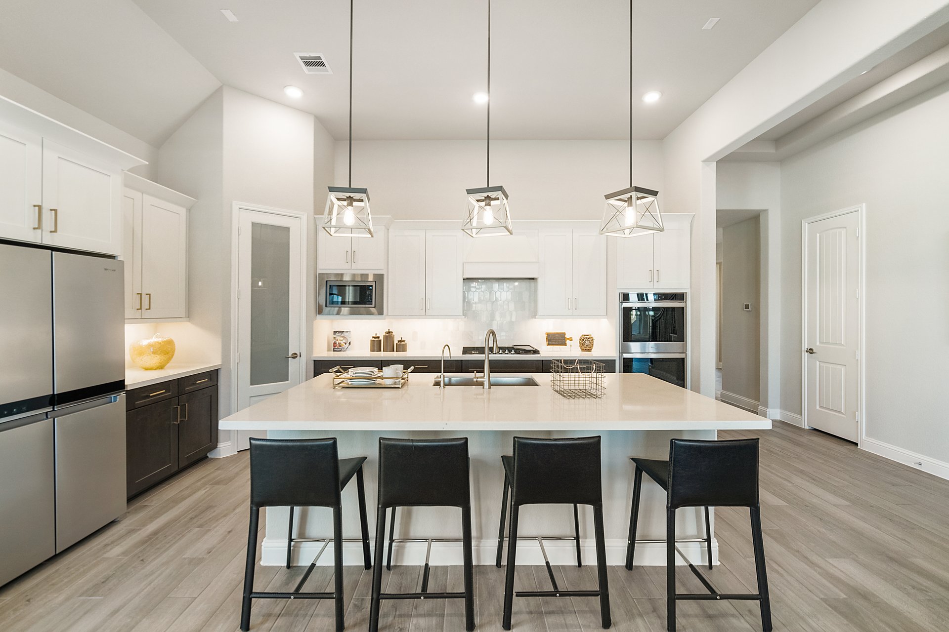 kitchen with pendant lights and 4 barstools