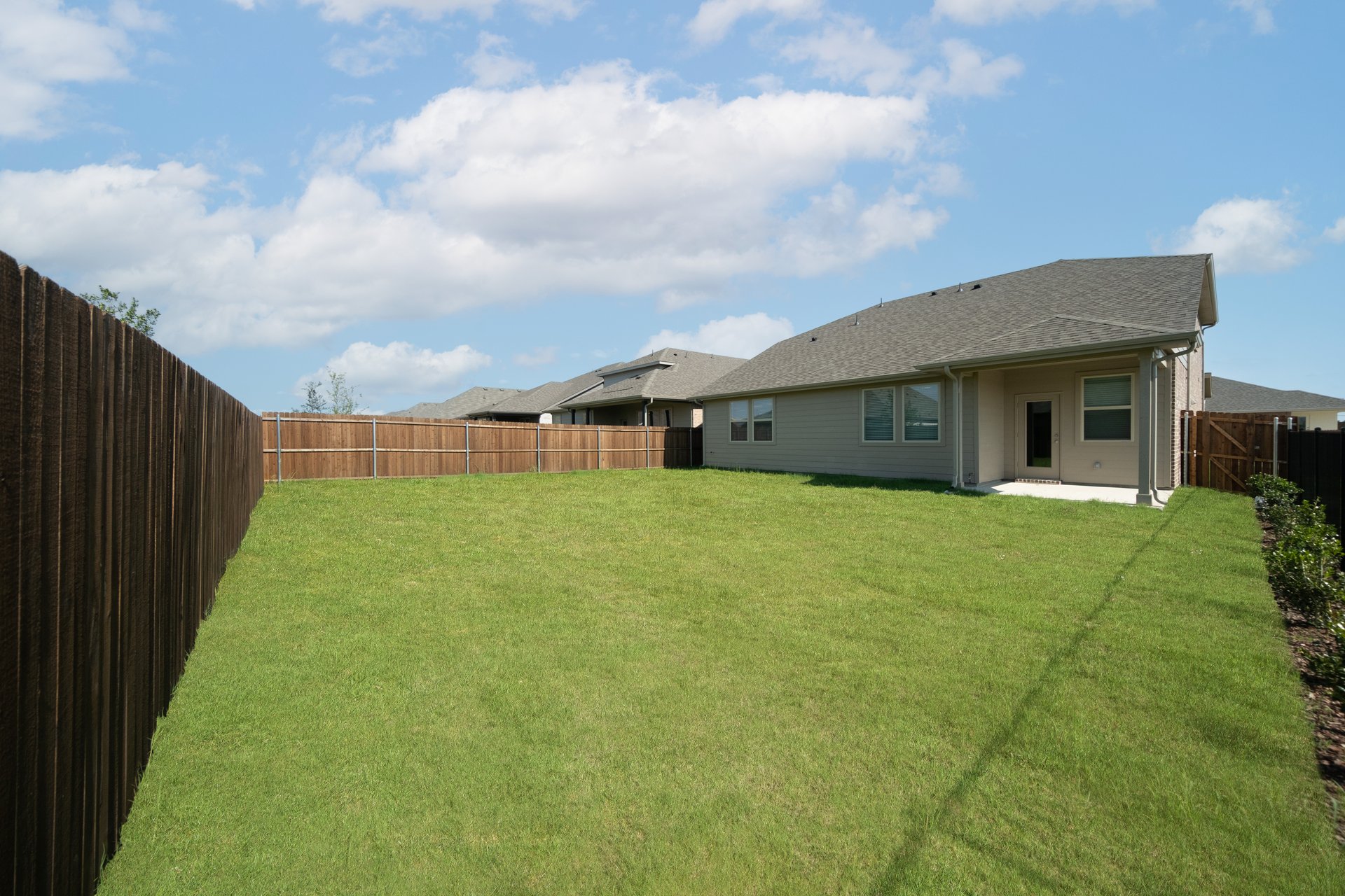 backyard with grass and covered patio