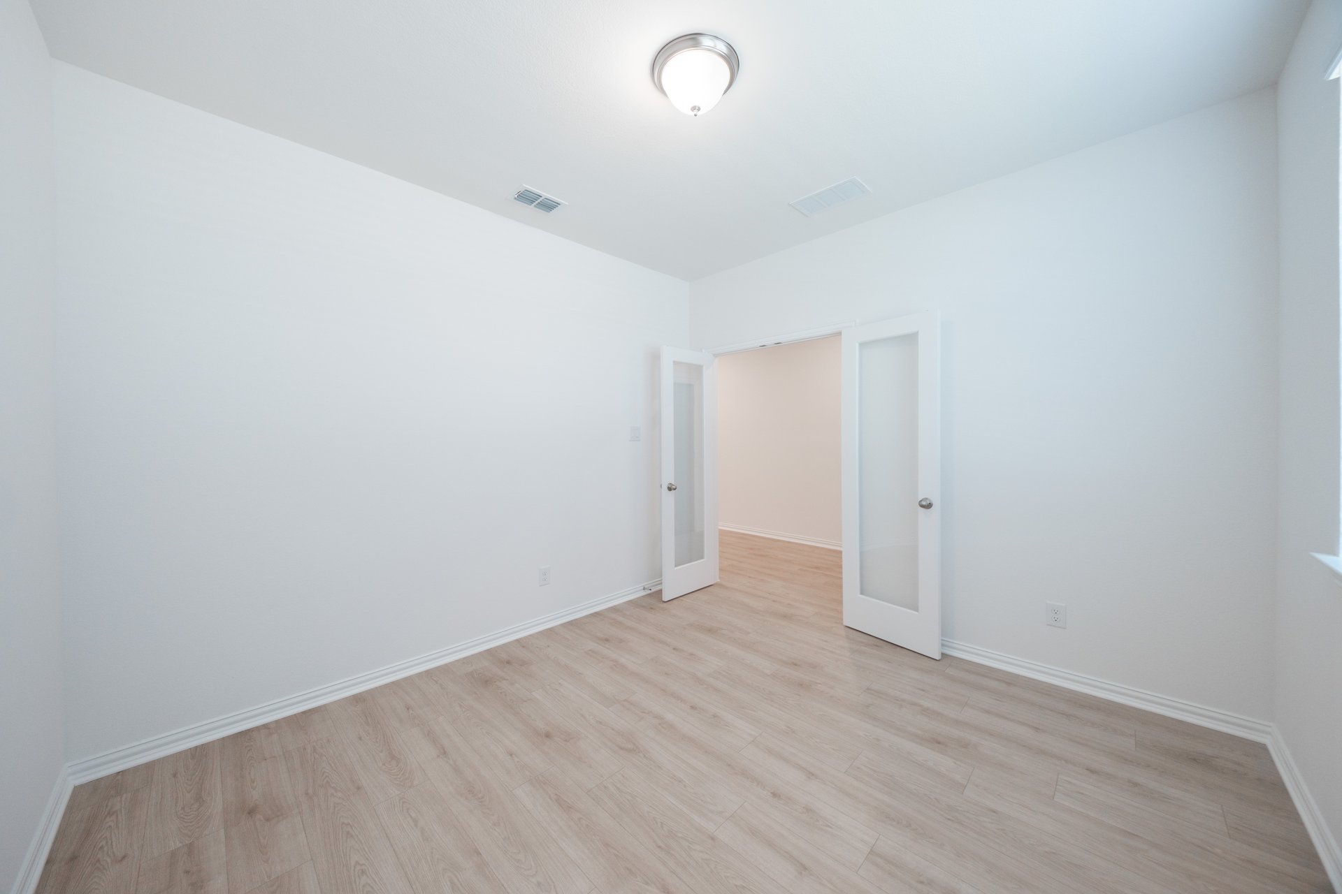 private study with wood floors and windows