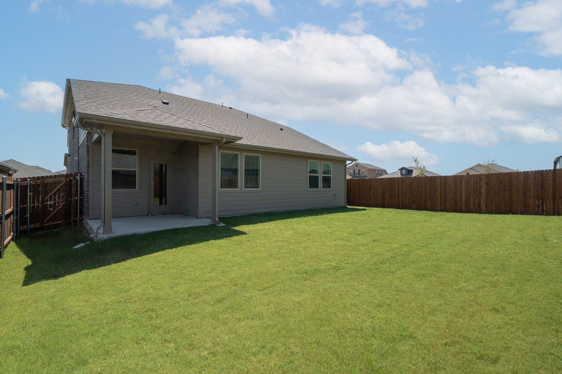 backyard with grass and covered patio