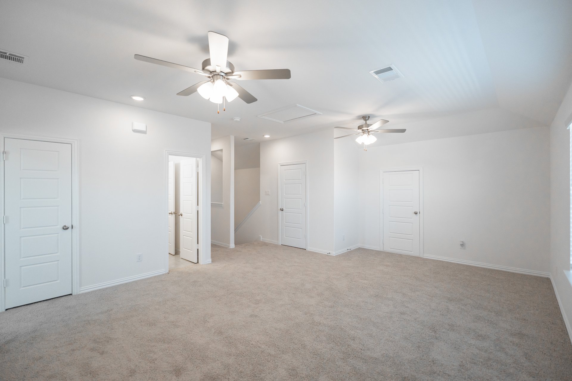 open gameroom with carpet and ceiling fan
