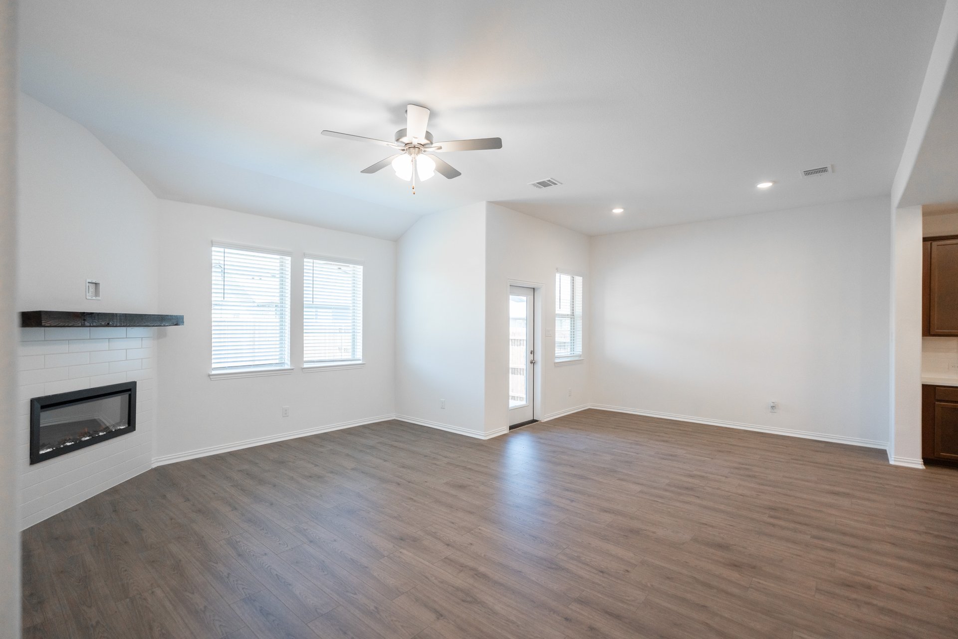 open great room with wood floors and fireplace
