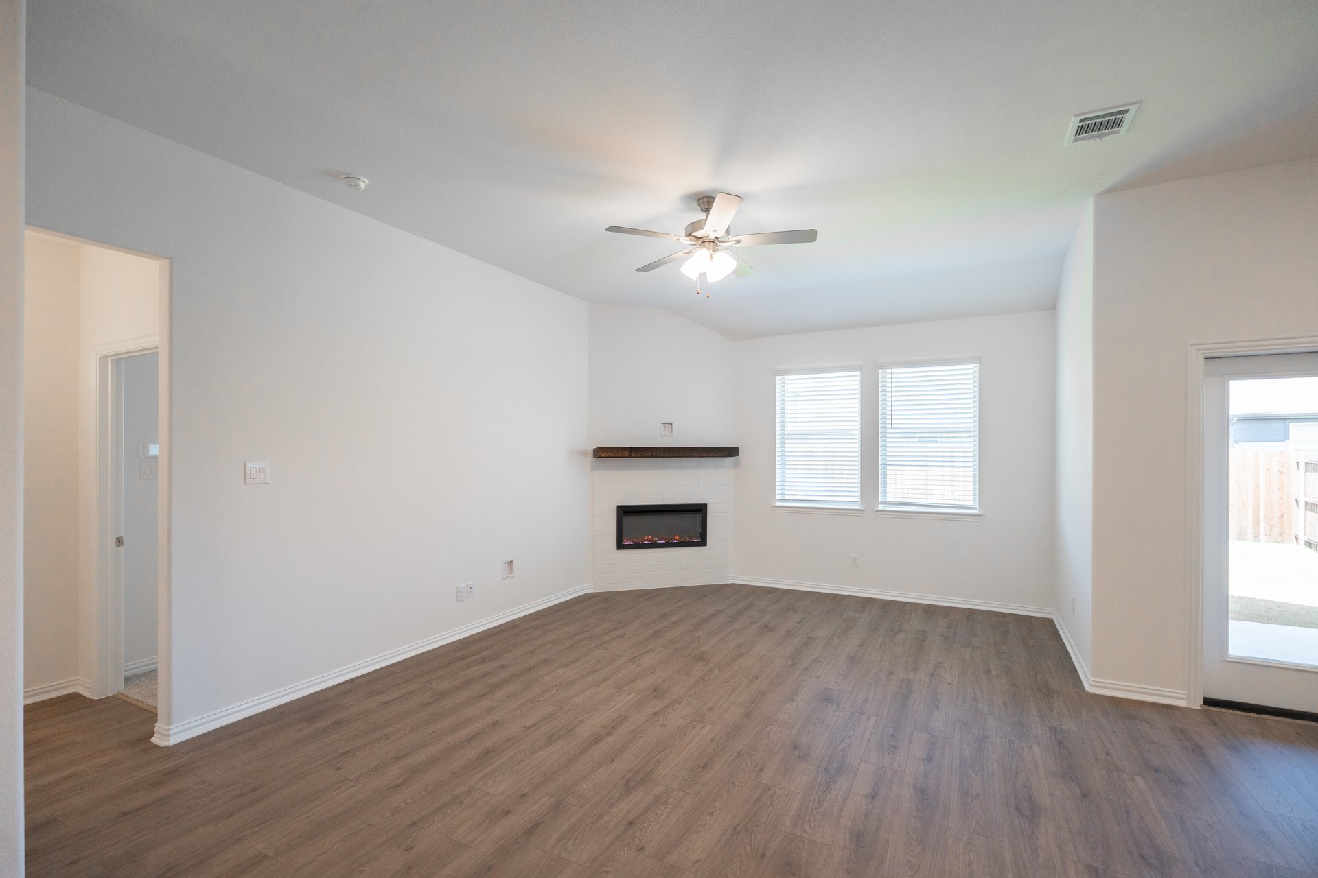 open great room with wood floors and ceiling fan