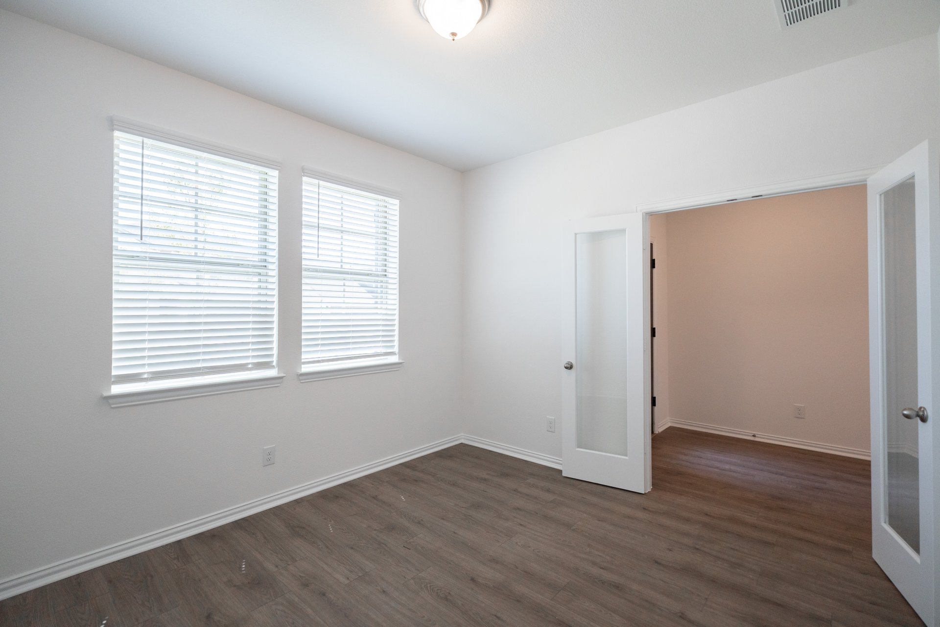 private study with wood floors and french doors