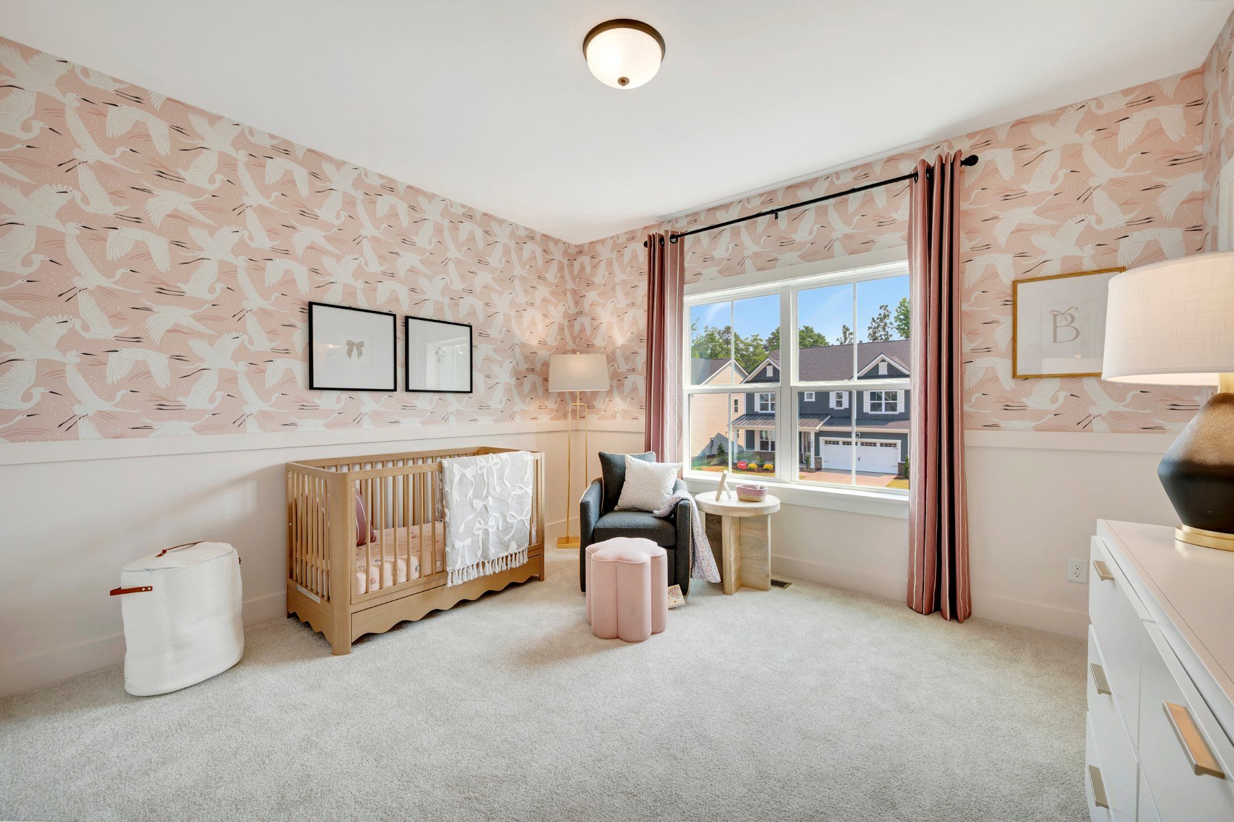 secondary bedroom with a crib and two windows