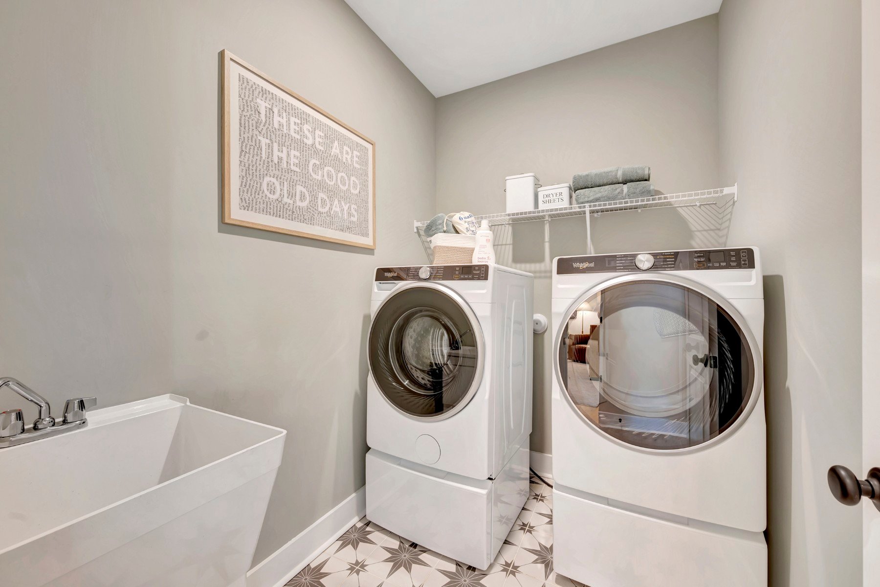 laundry with a wire shelf and a sink
