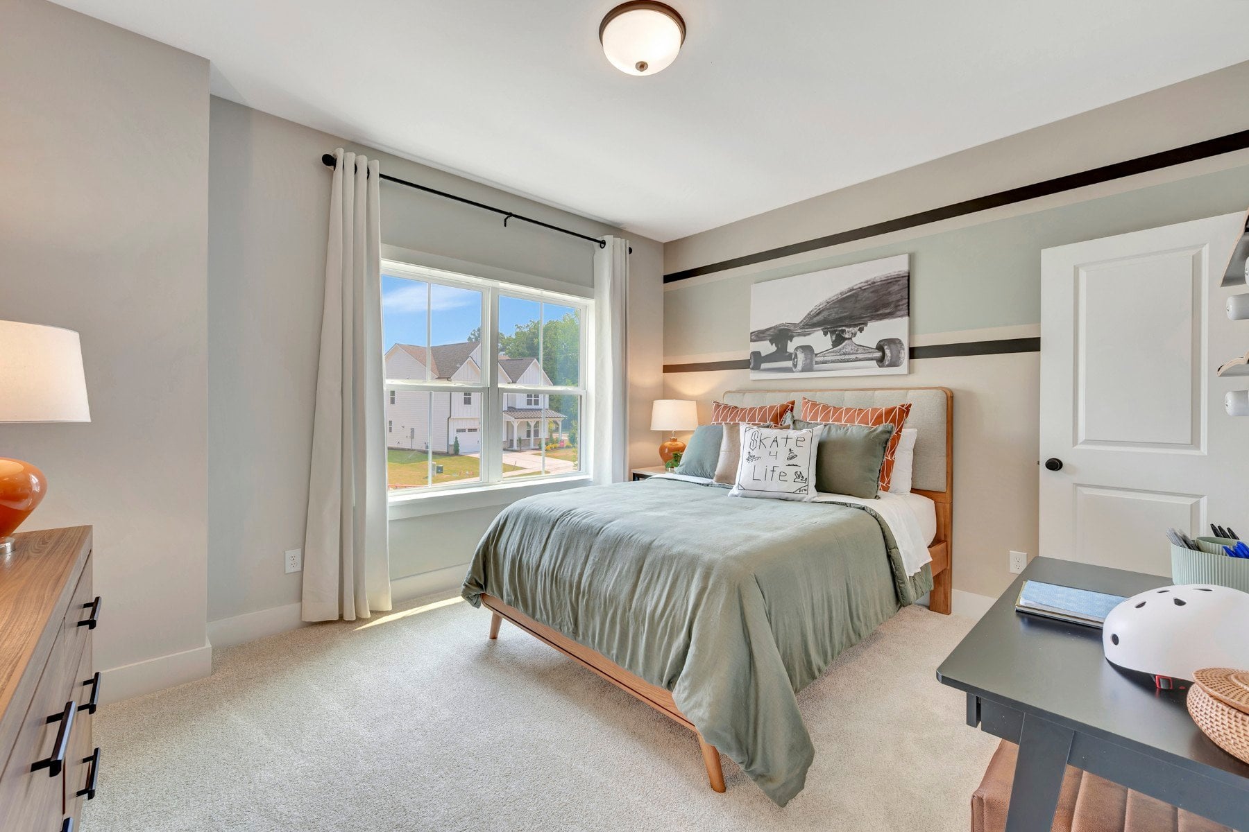 secondary bedroom with two windows and carpet