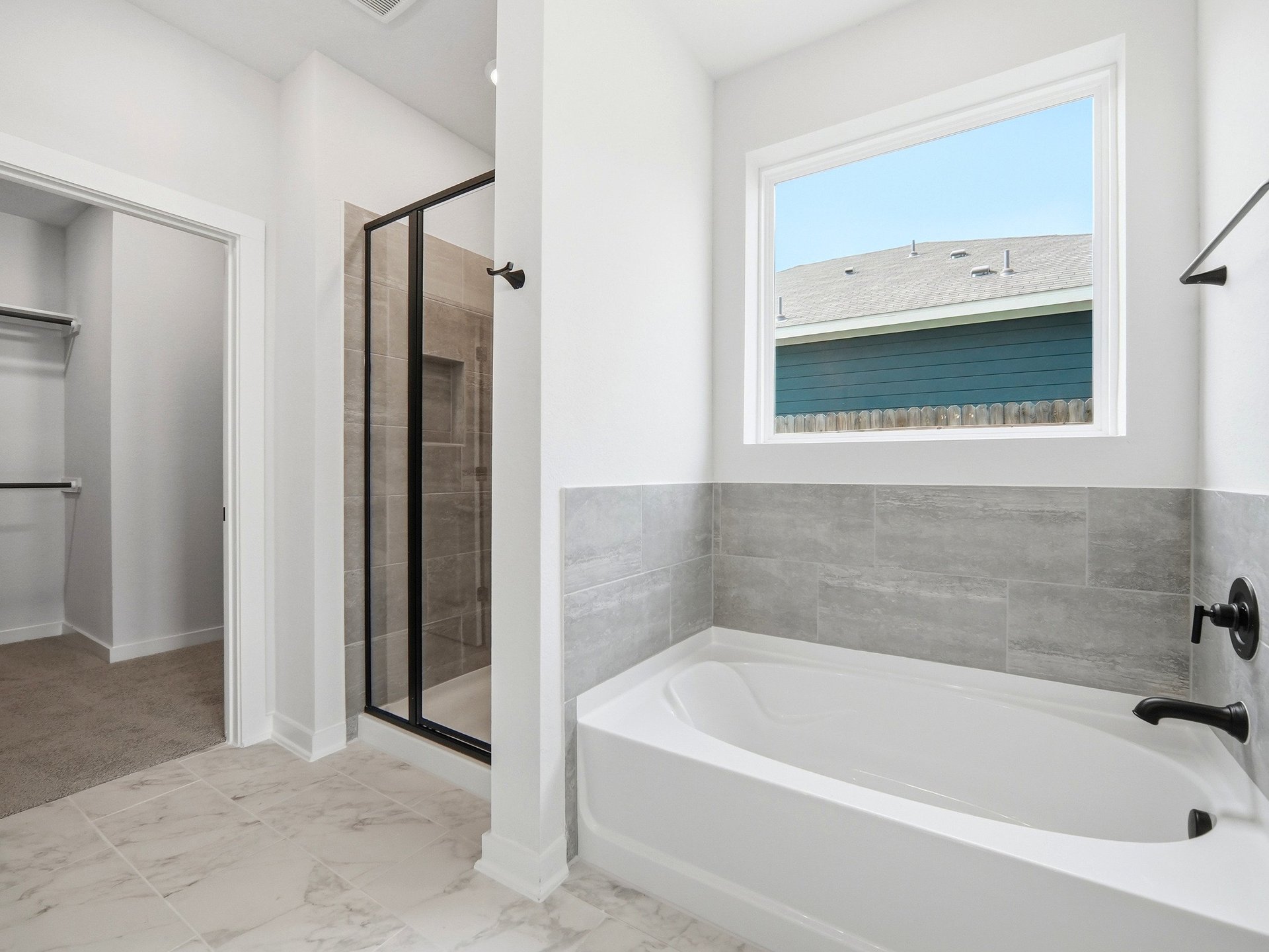 bathroom with walk in shower and tub
