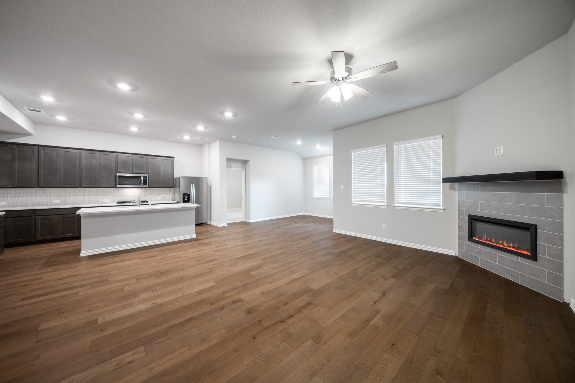 open great room with wood floors and fireplace
