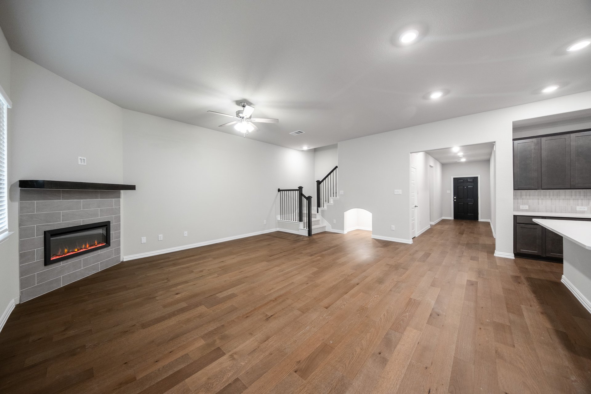 open great room with wood floors and fireplace