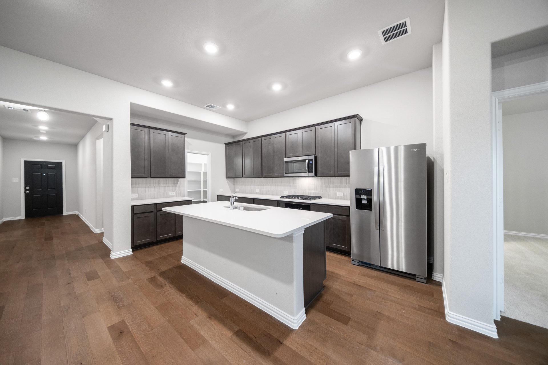 open kitchen with wood floors and large island