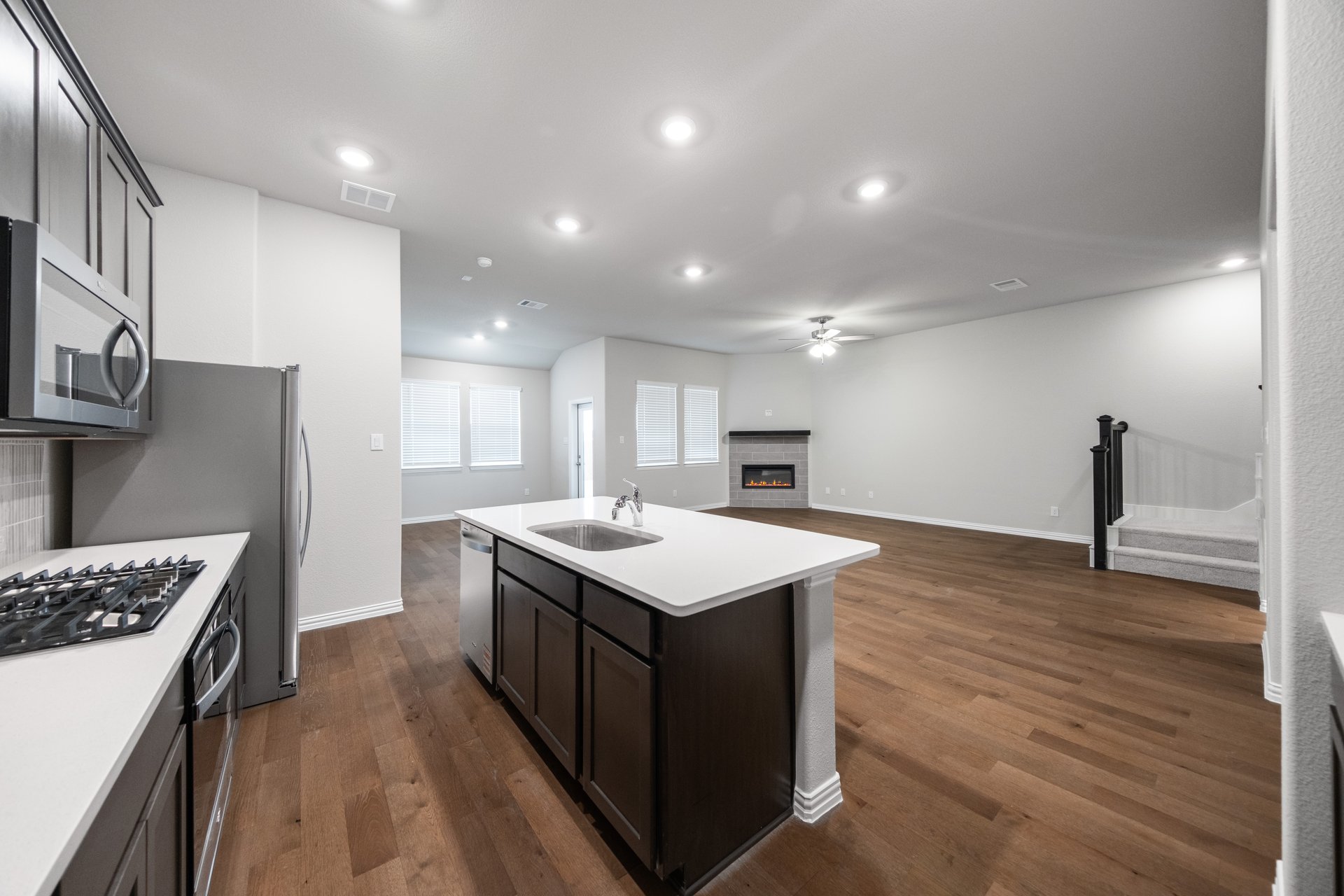 open kitchen with wood floors and large island