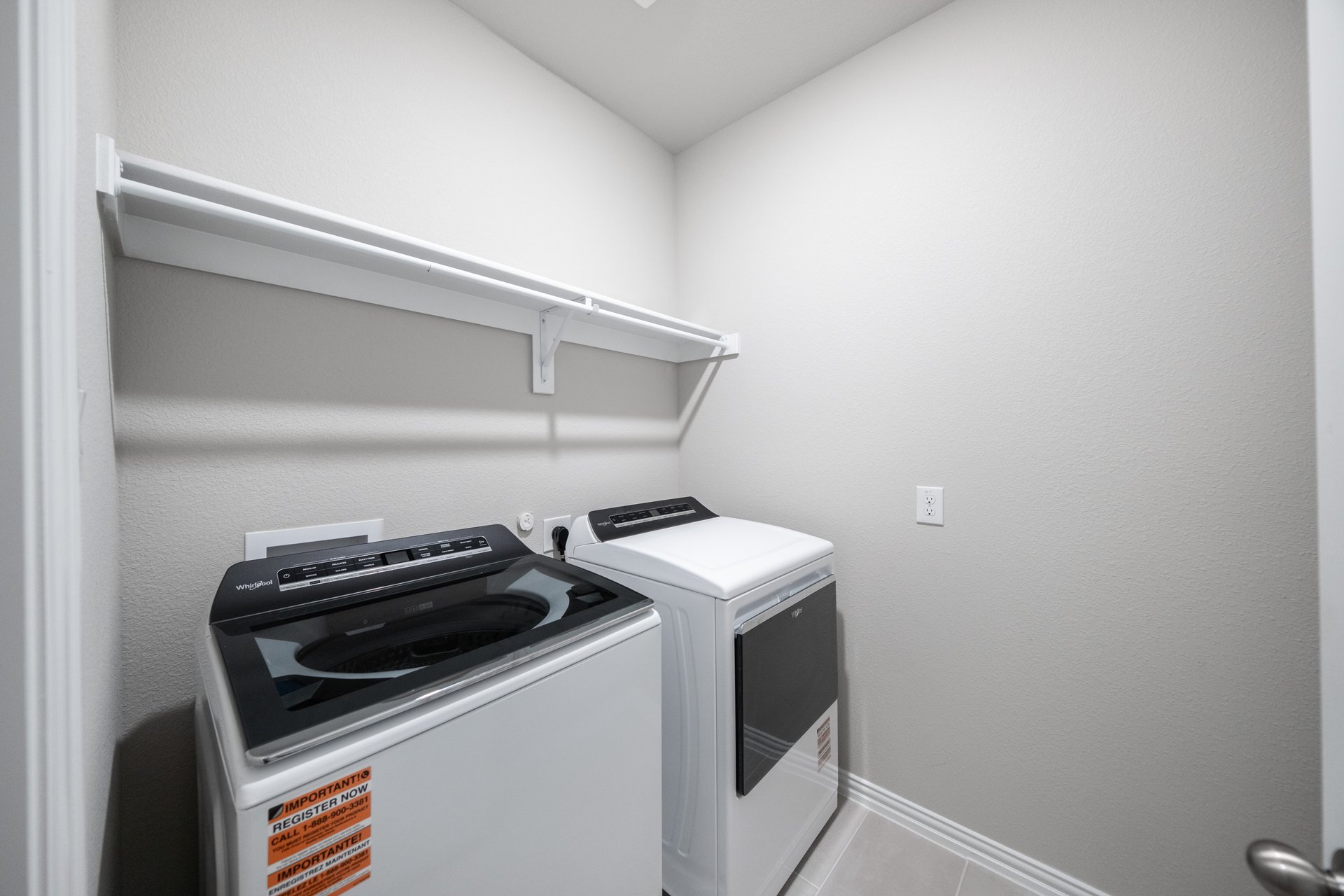 laundry room with washer, dryer, and tile floors