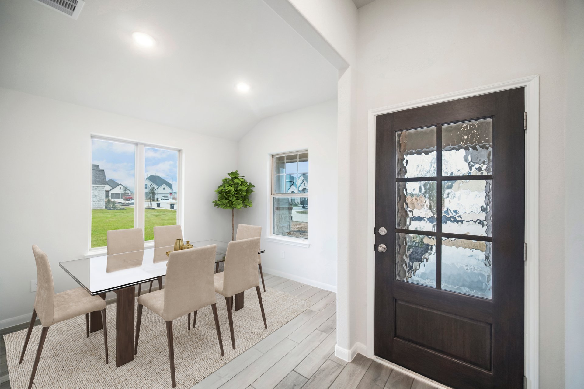 foyer with front door view and dining set