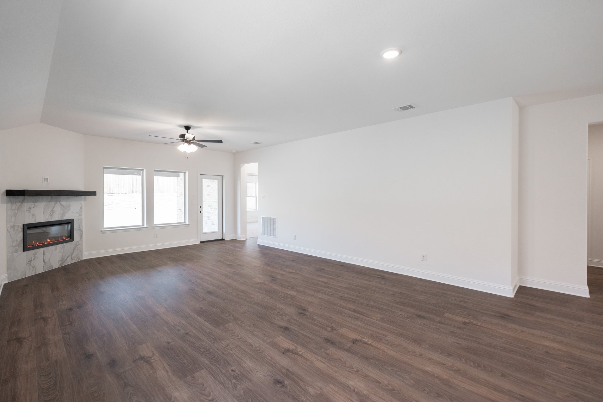 open great room with wood floors and fireplace