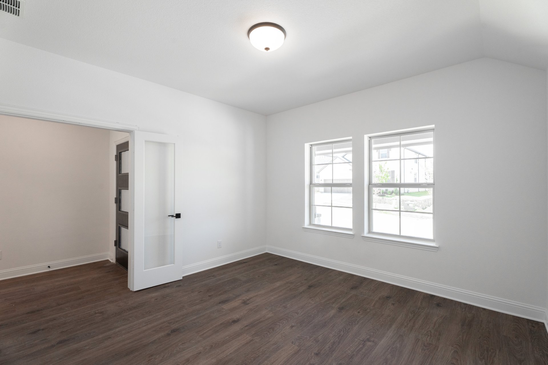 private study with wood floors and french doors