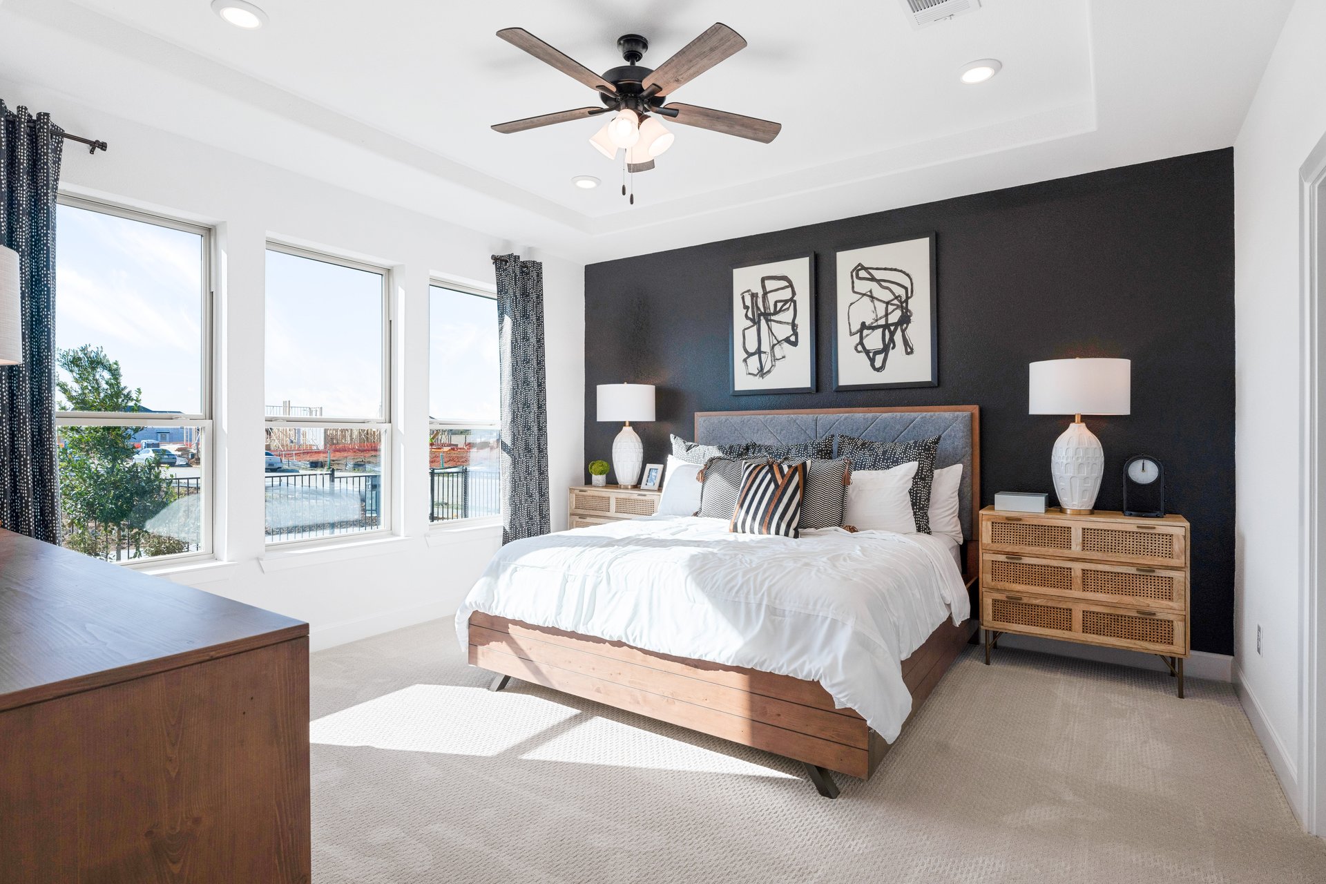 bedroom with large windows and ceiling fan 