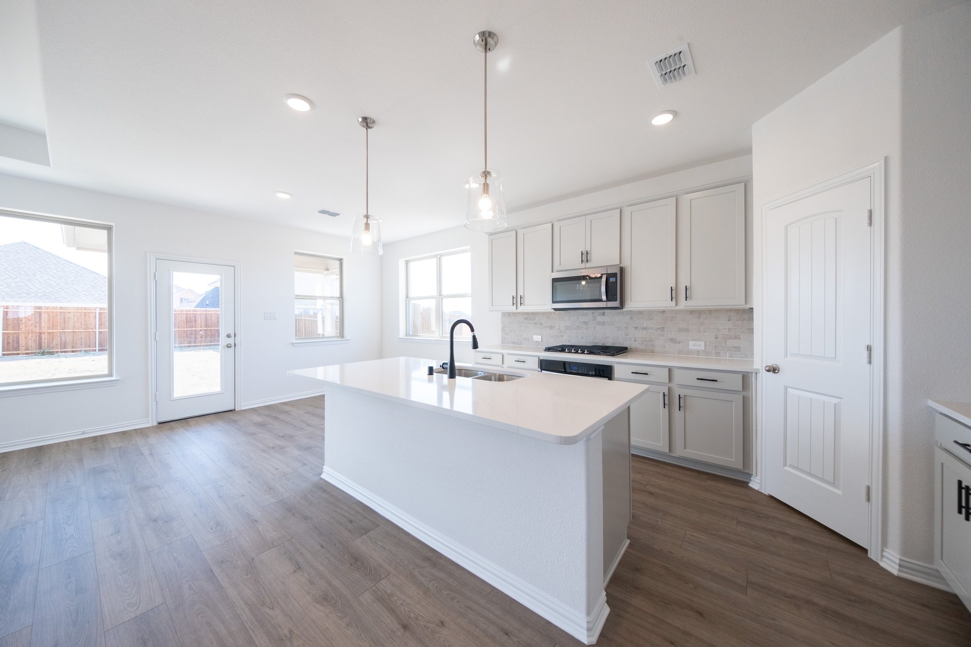 open kitchen with white quartz countertops