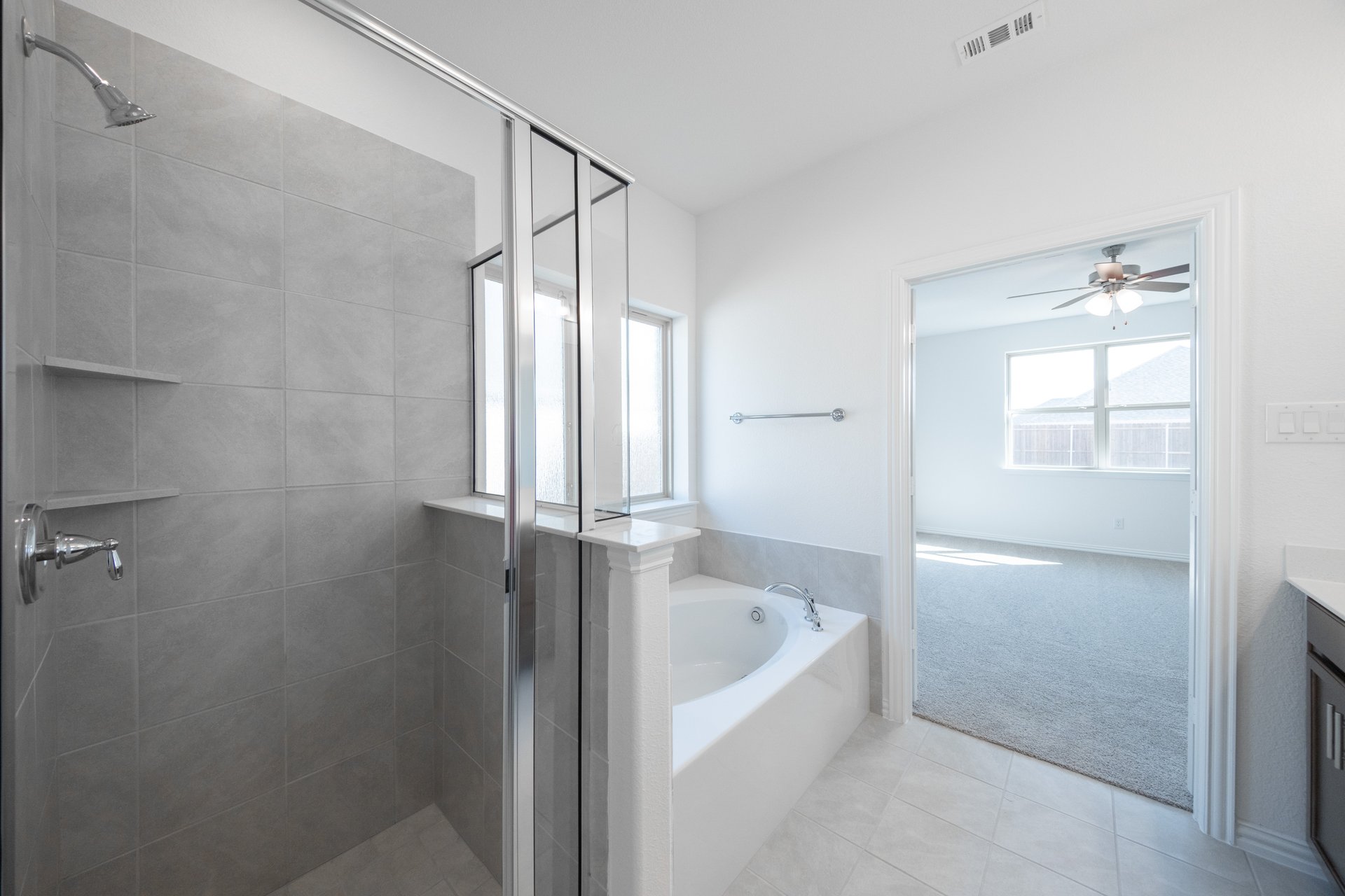 spacious primary bathroom with soaking tub and walk-in shower