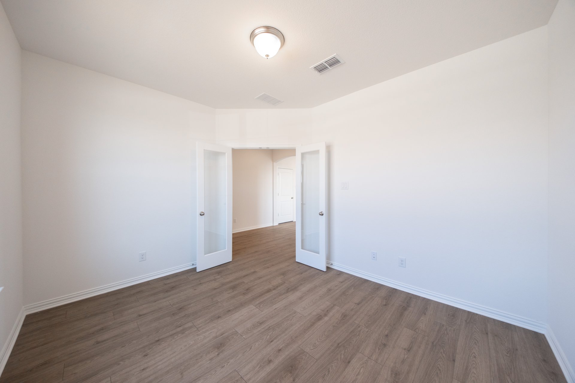 spacious study with hardwood flooring