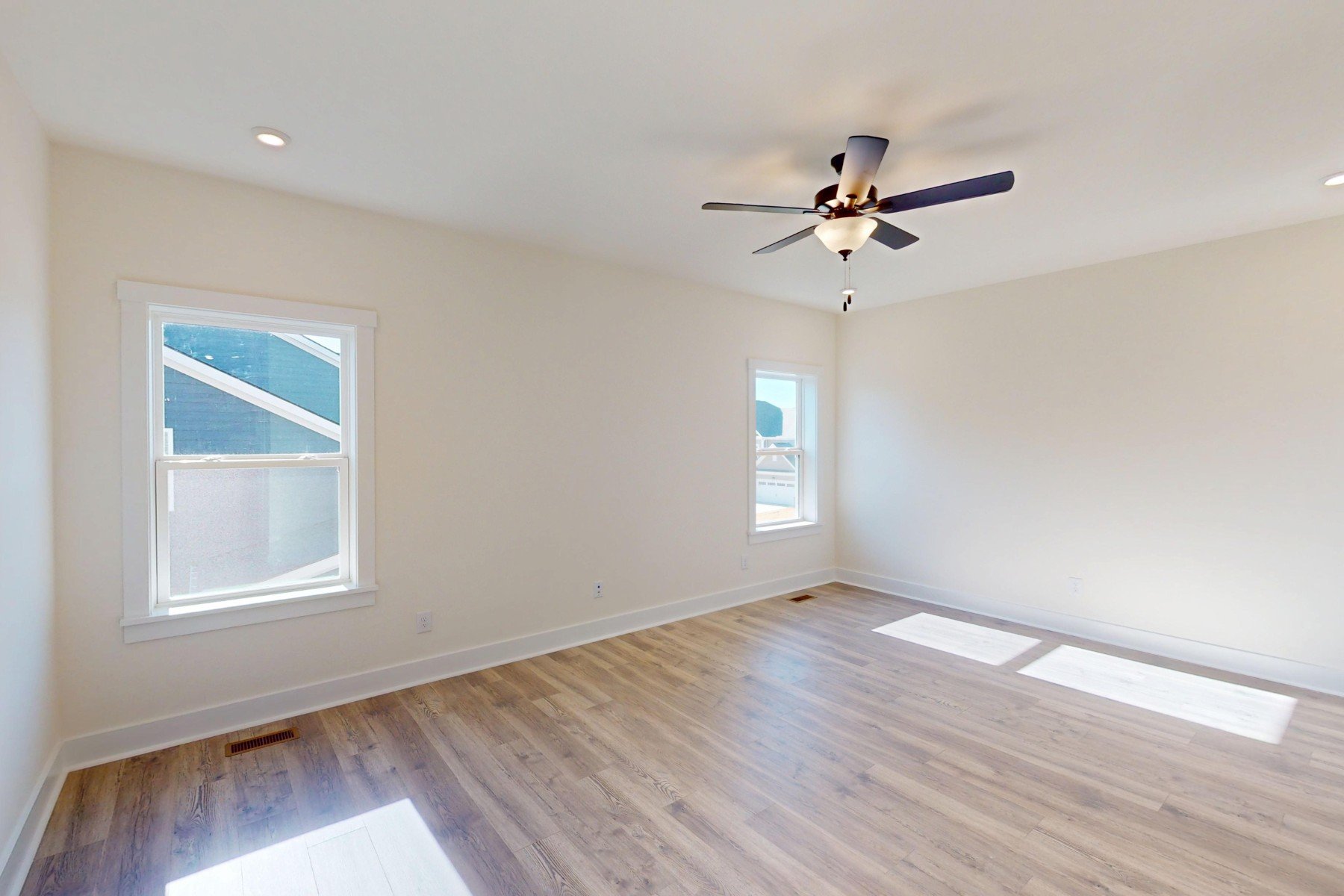 loft with windows and a ceiling fan