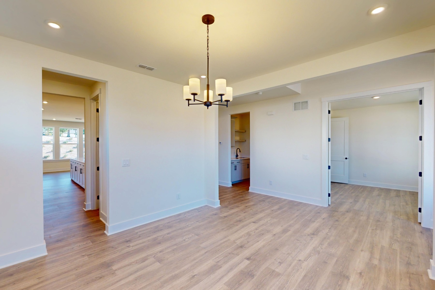 dining room with lighting and access to kitchen