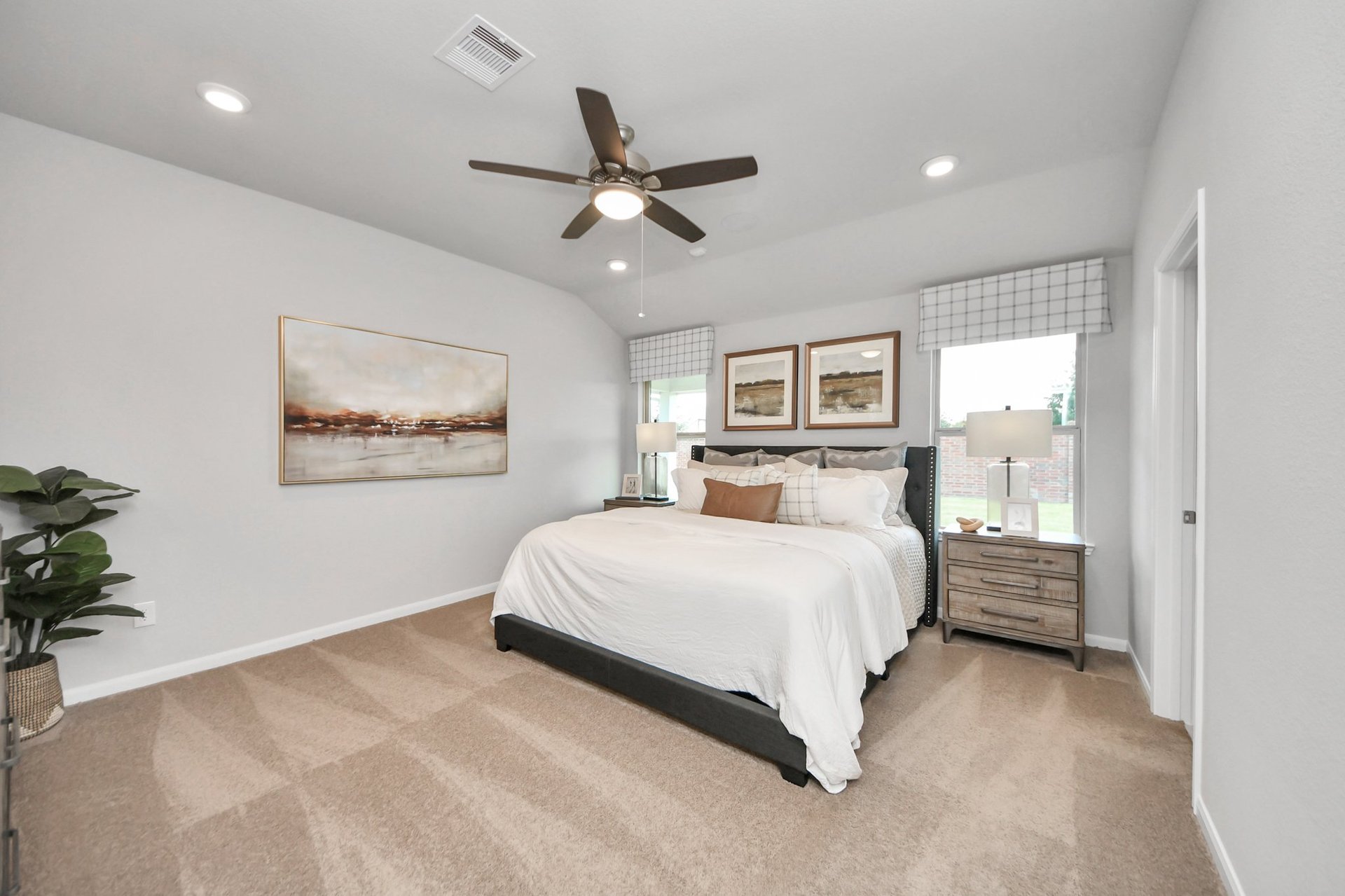 primary bedroom with carpet and windows