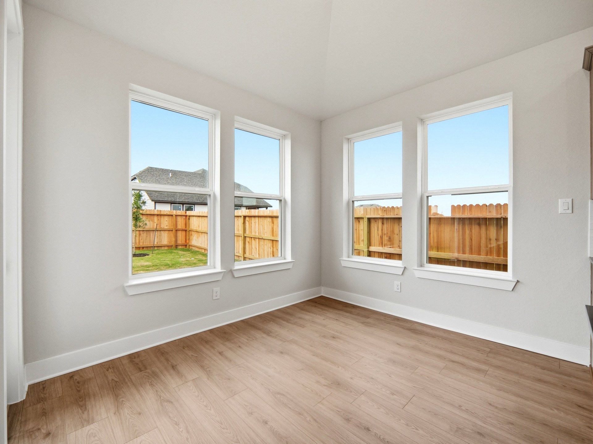 dining room with brown flooring and windows 