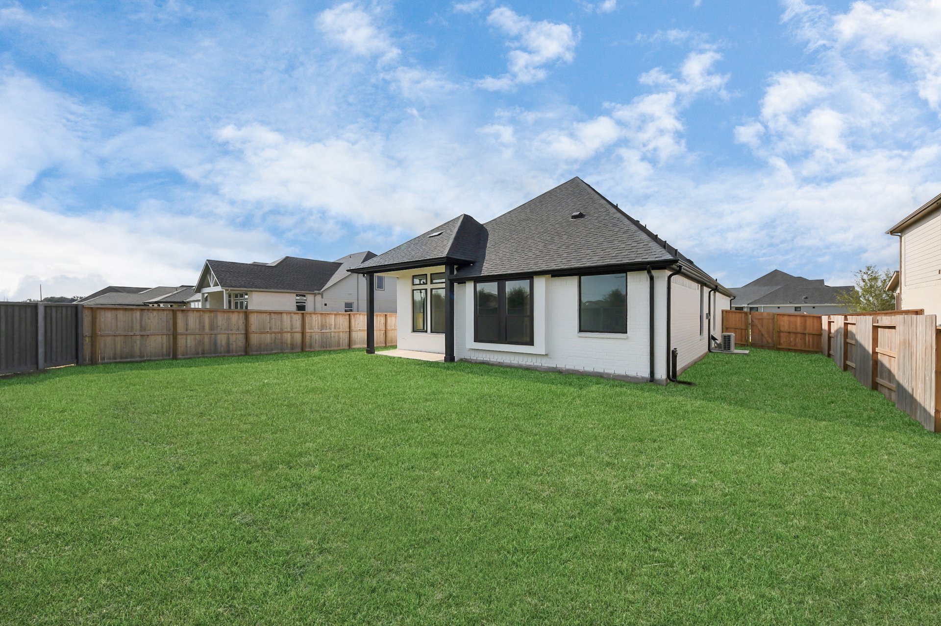 spacious yard with covered back porch and privacy fench