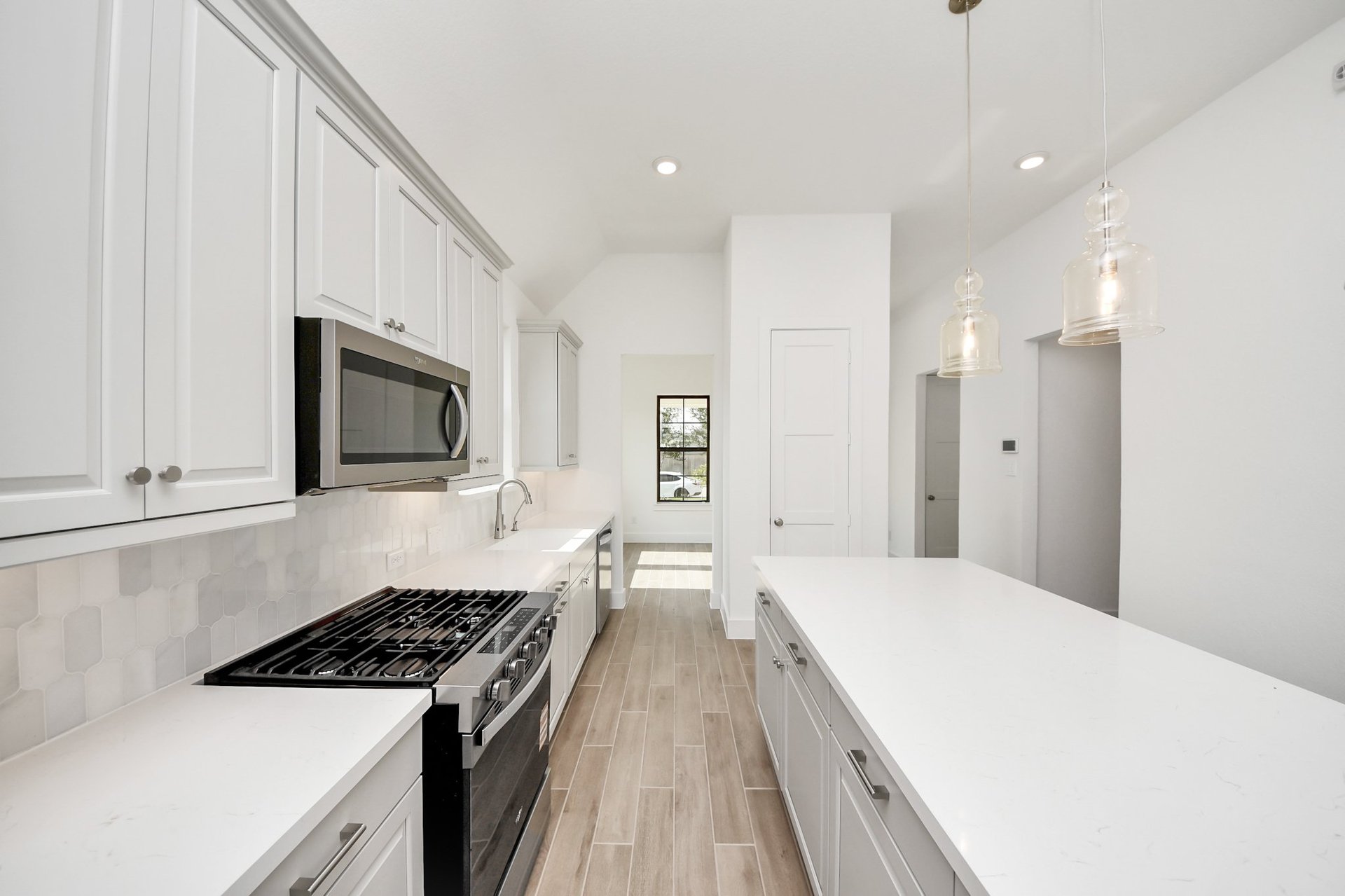 stainless appliances and pendant lighting