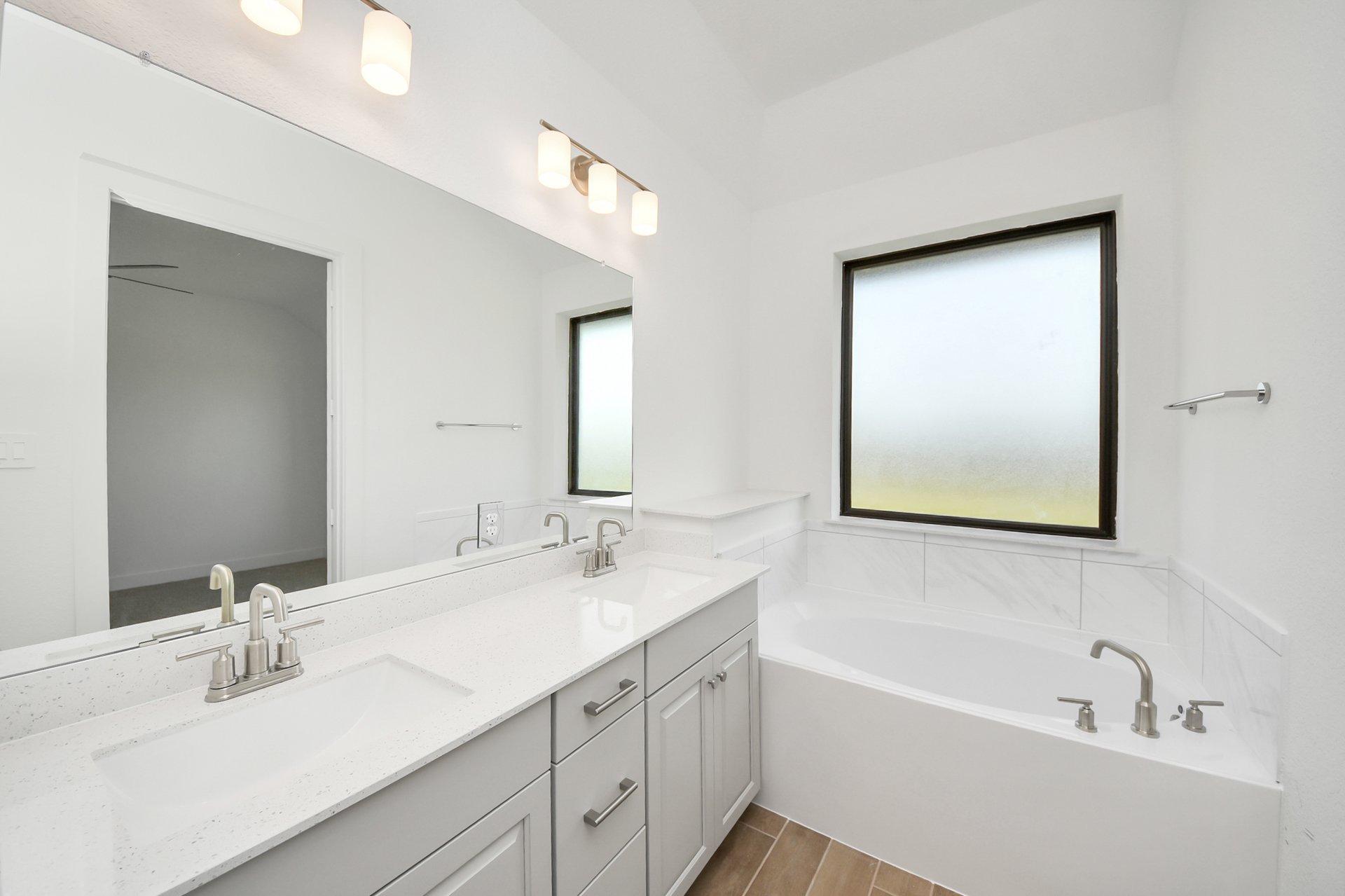 soaker tub with light colored tile surround