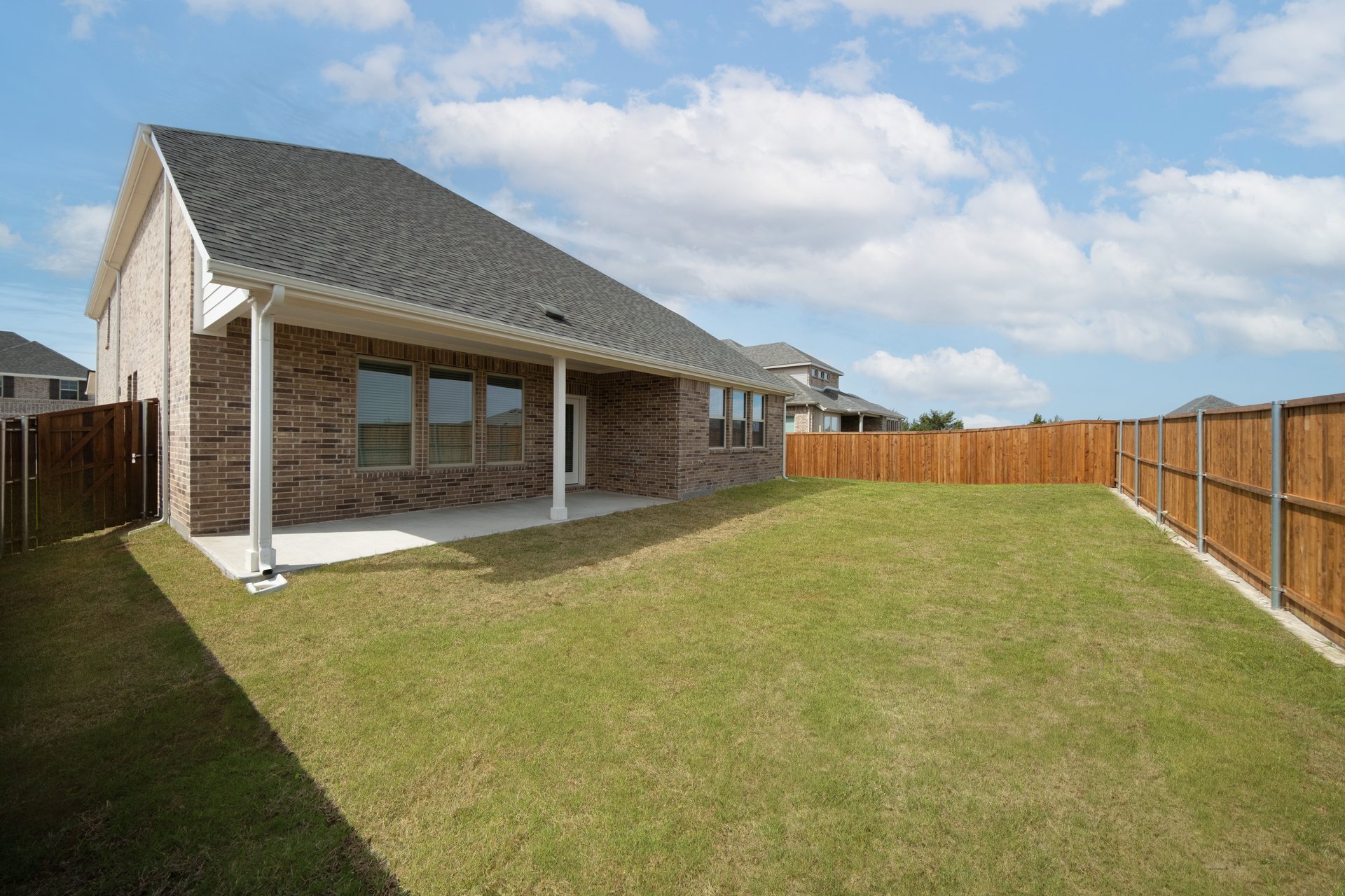backyard with grass and covered patio