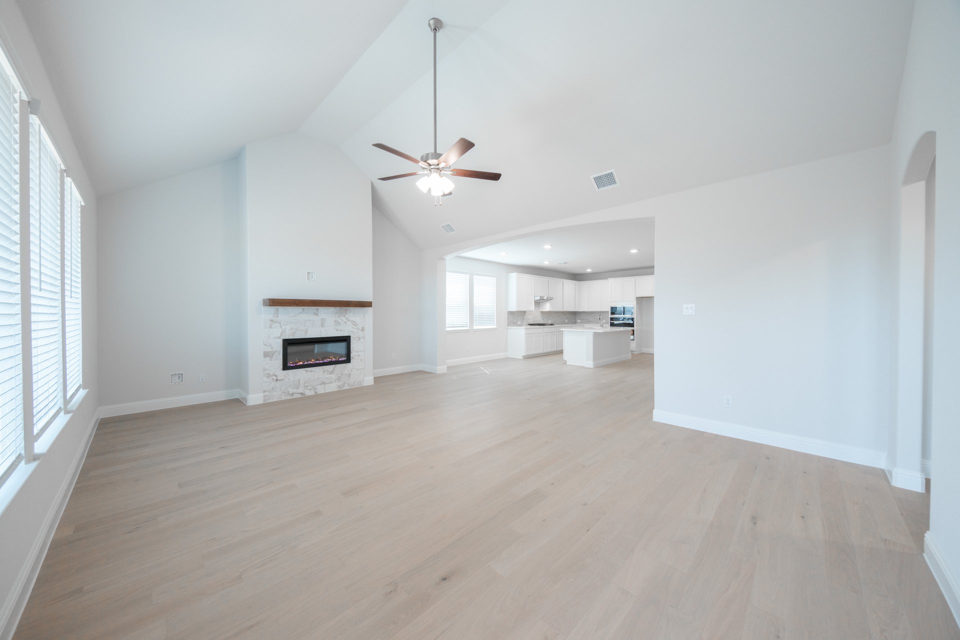 open great room with wood floors and fireplace