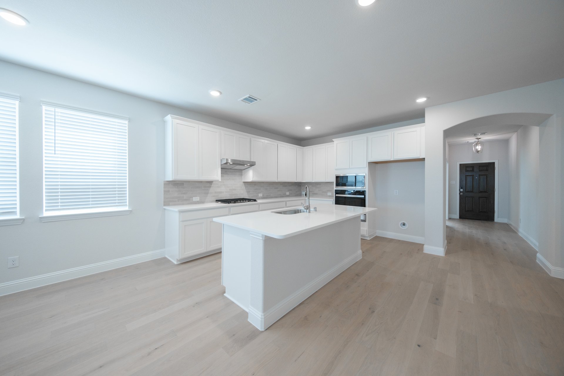 open kitchen with wood floors and island