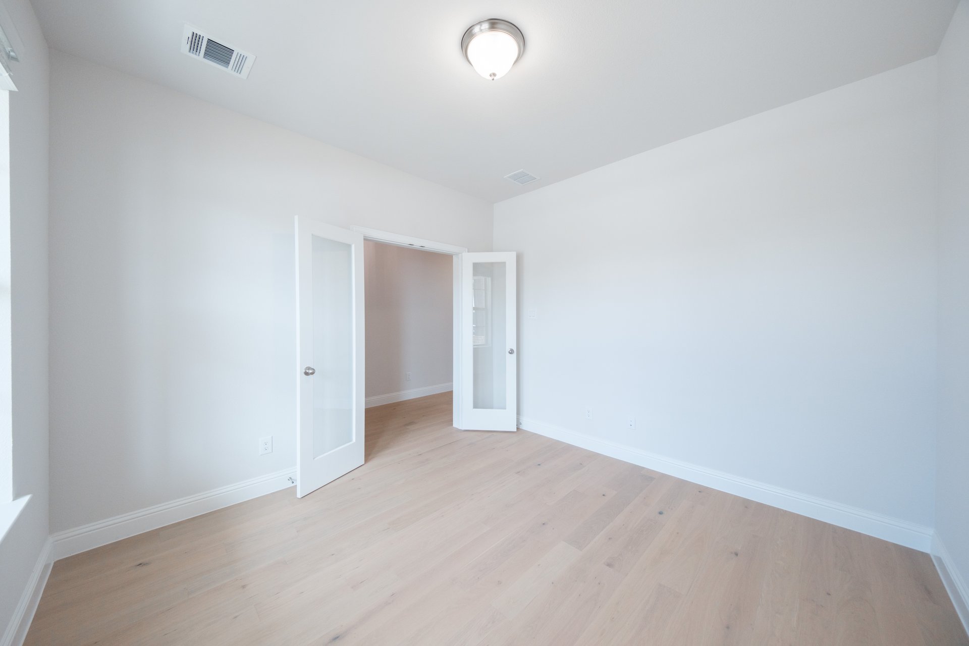 private study with wood floors and french doors