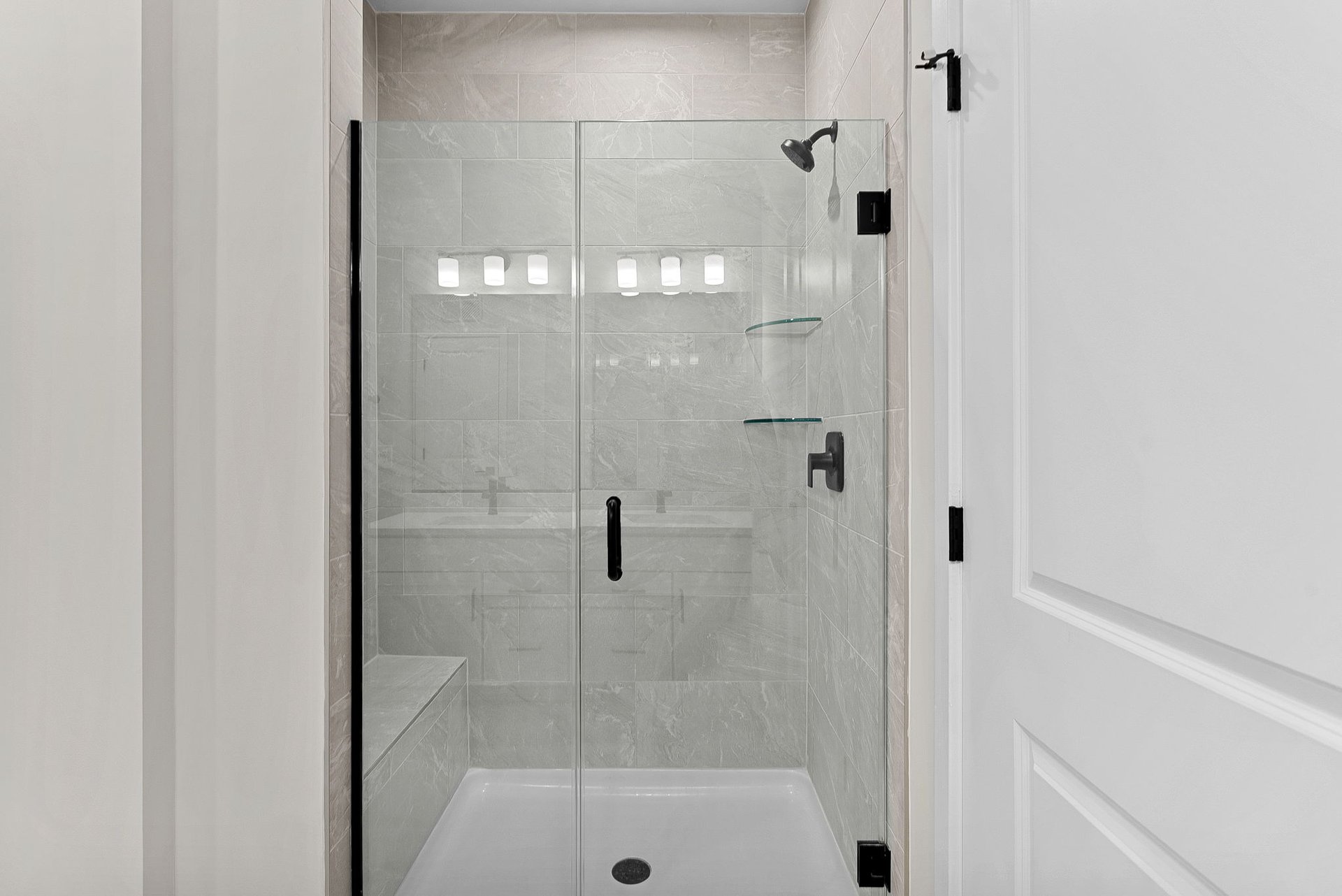 primary bathroom with shower with black hardware and tile