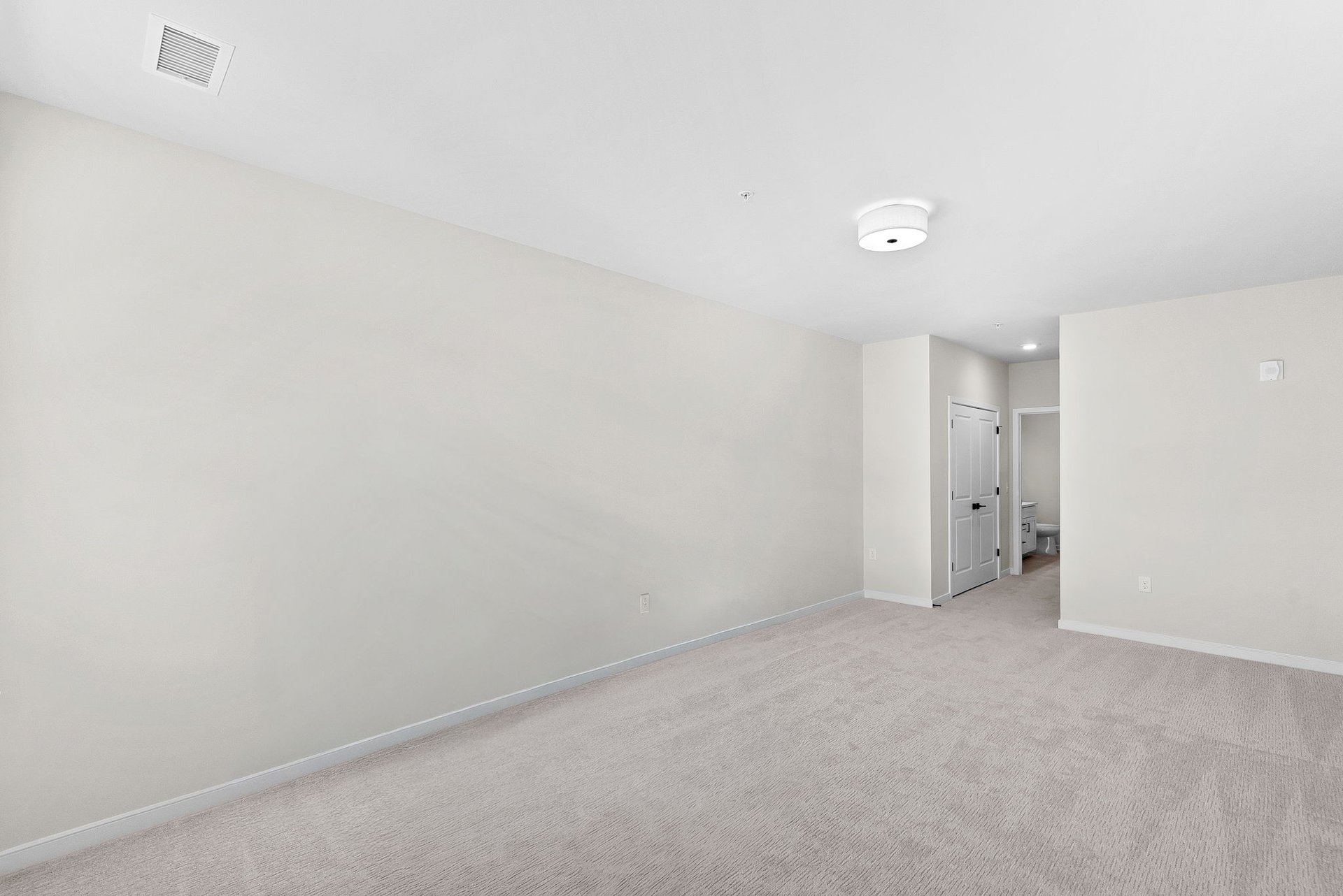 open secondary bedroom with carpet