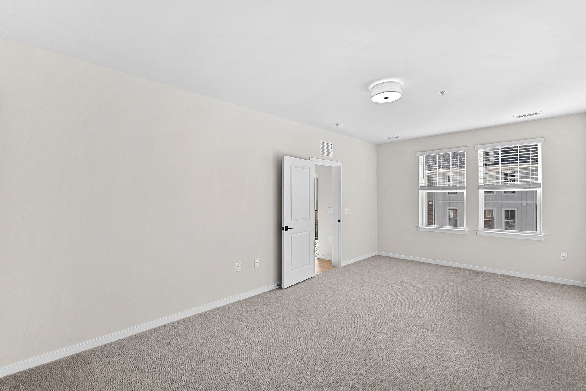open primary bedroom with carpet