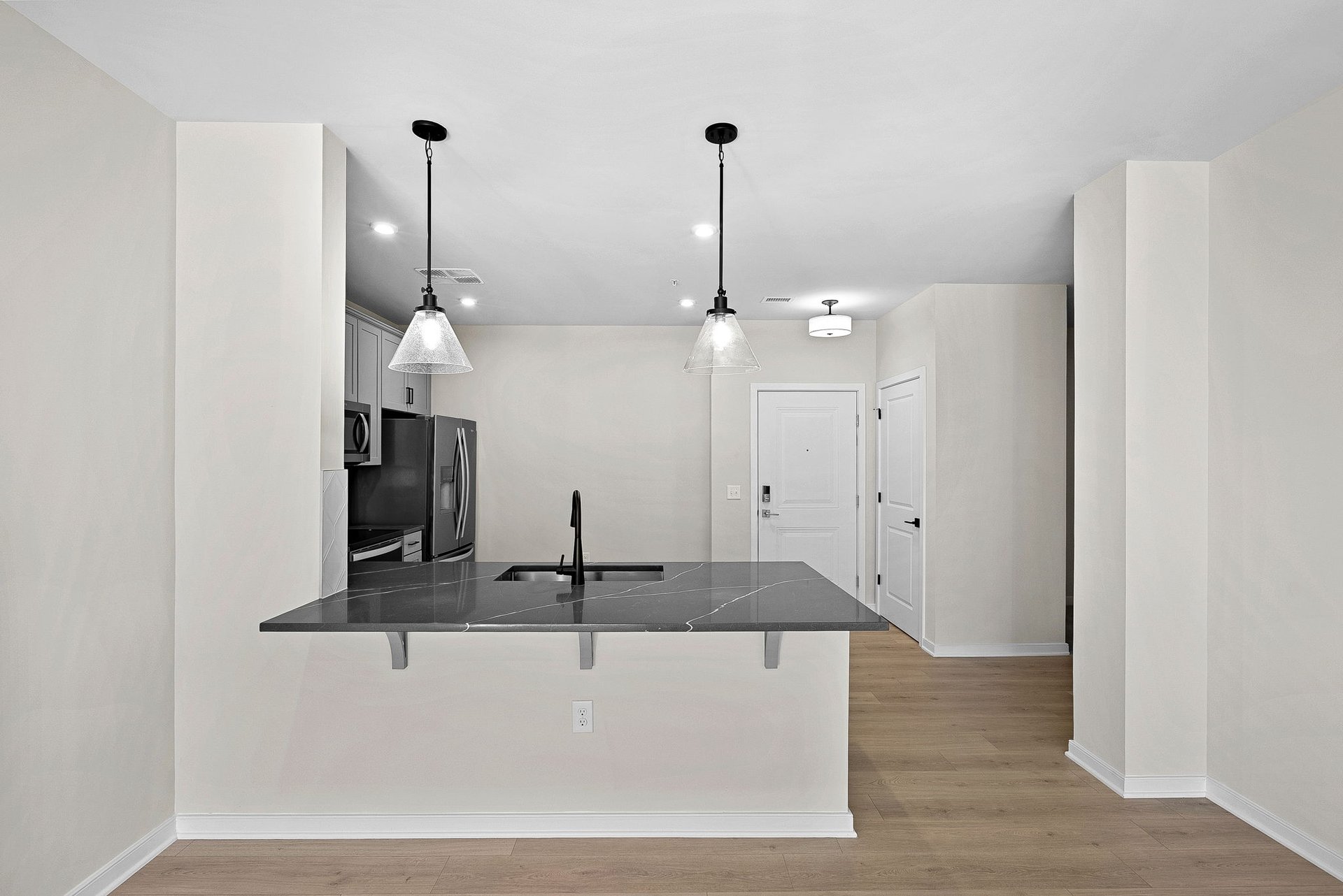 kitchen with quartz countertops and pendant lighting