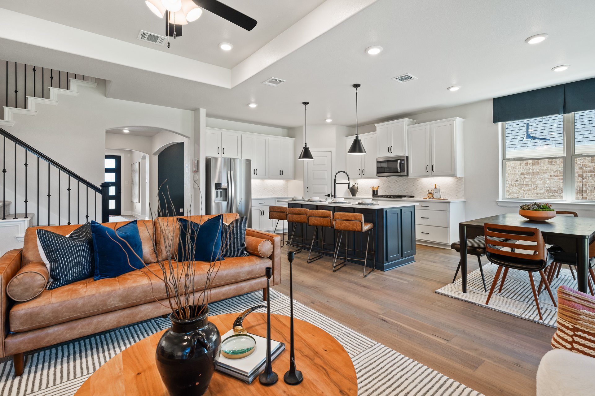 open great room with wood floors and ceiling fan