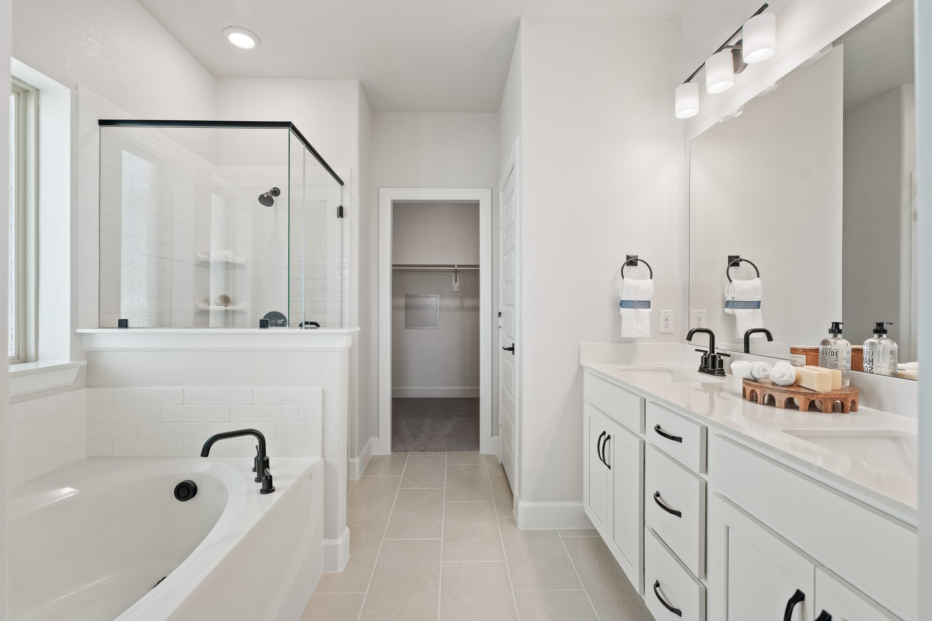 primary bedroom with carpet and windows