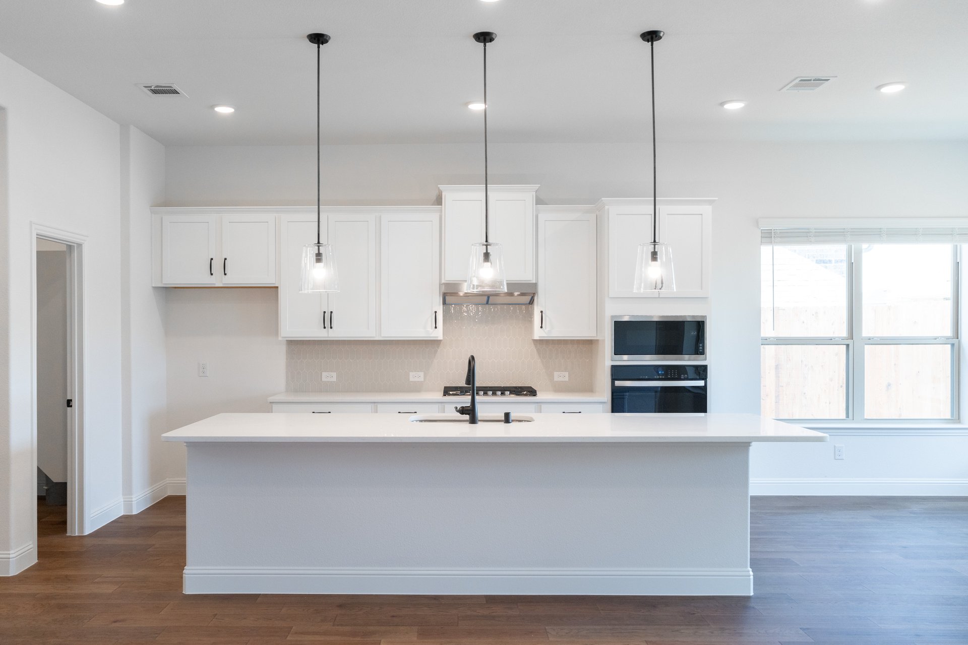 open kitchen with wood floors and island