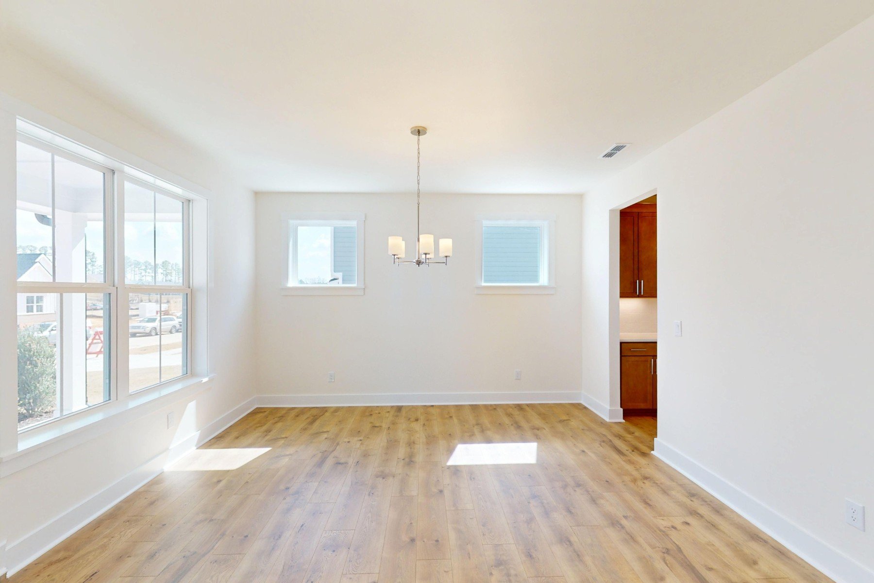 dining room with four windows and access to the kitchen