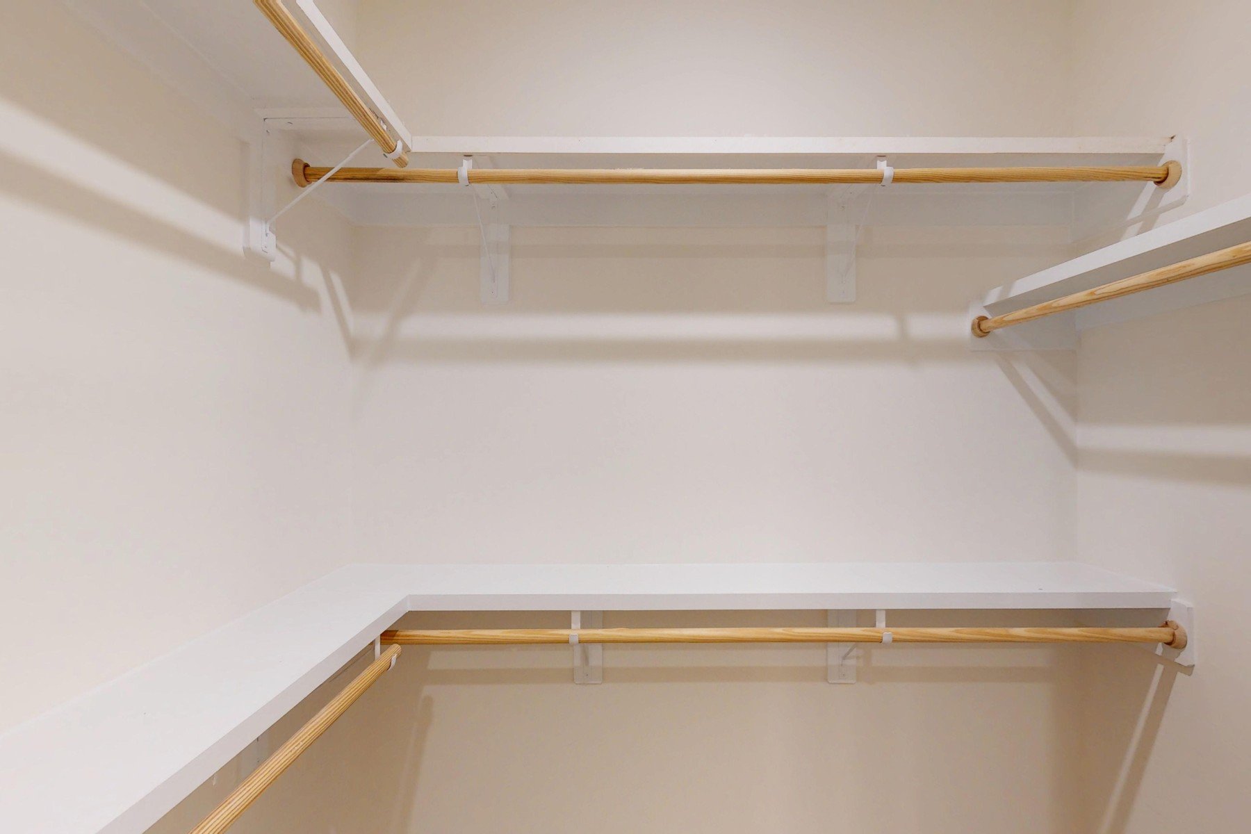 primary closet with wooden shelves