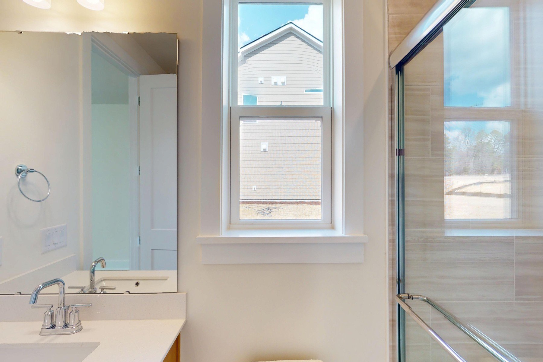 first floor bathroom with a walk-in shower and a window